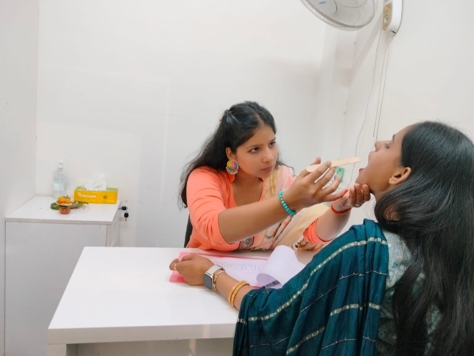 Speech therapist checking a patient